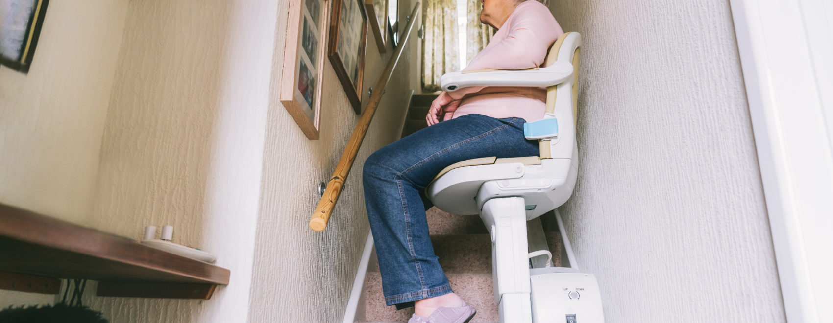 Senior woman using a used stairlift