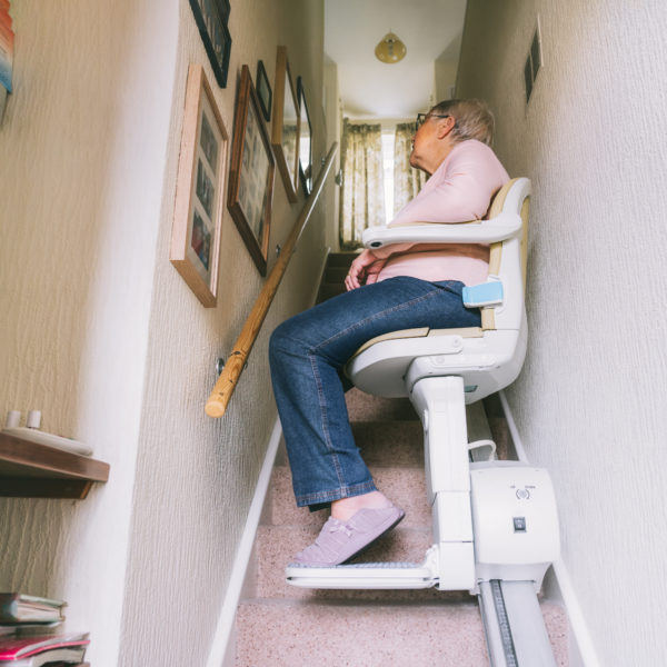 Senior woman using a used stairlift